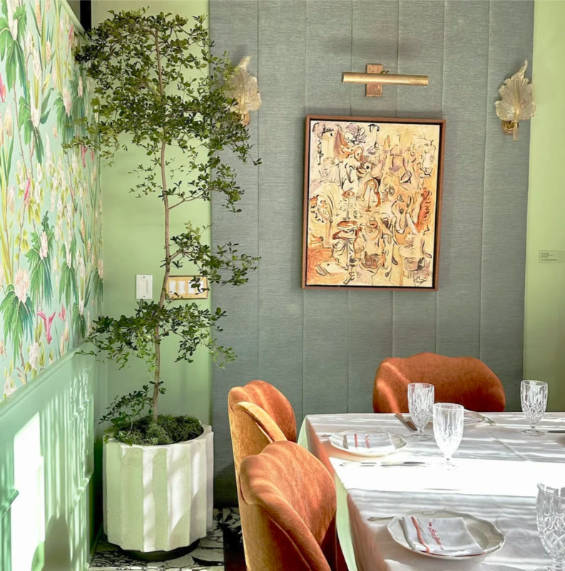 A single sculptural tree carrying a dining corner