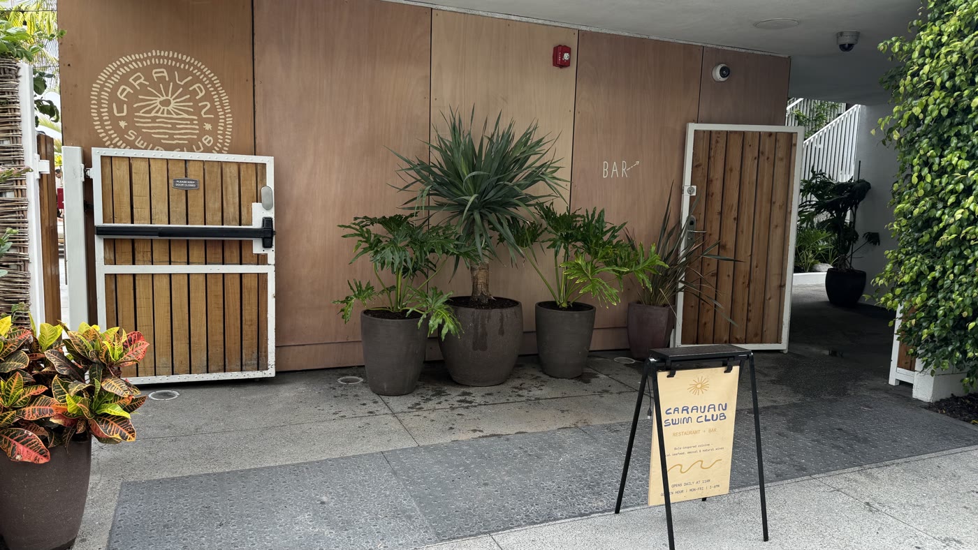 Potted palms flanking the entry